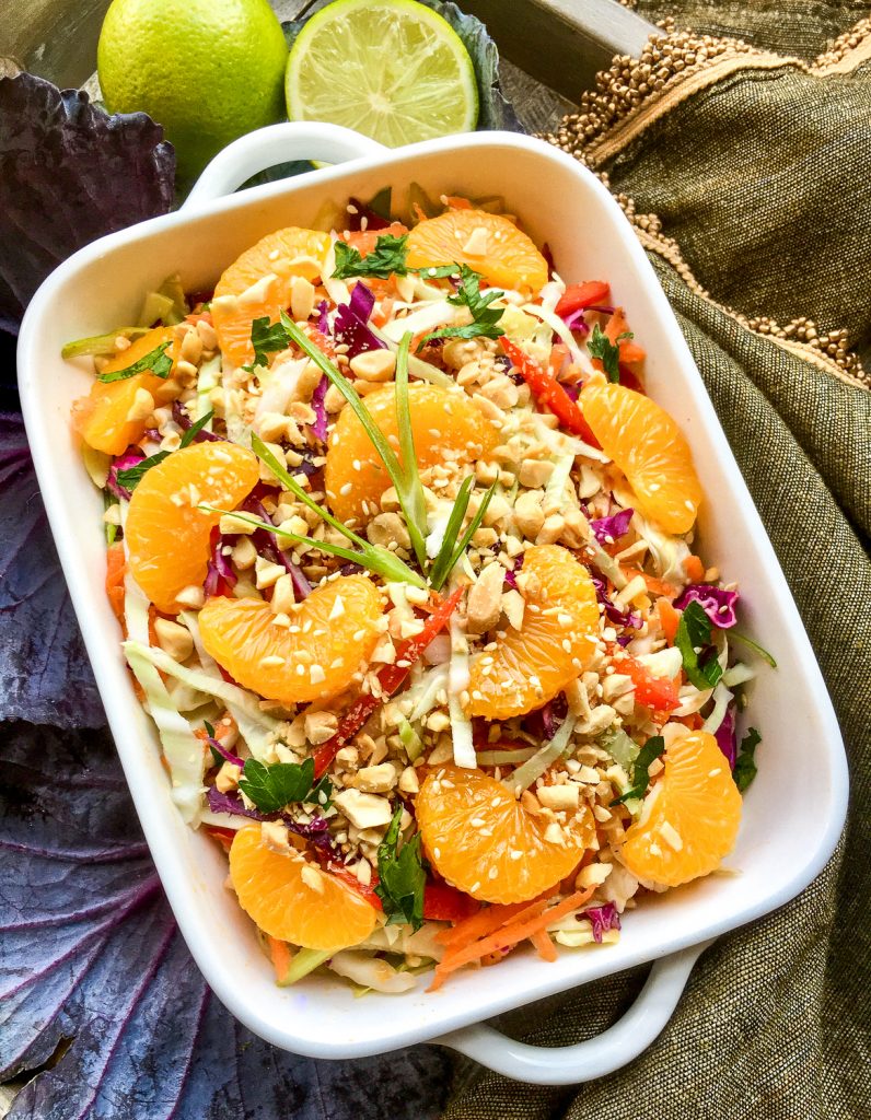 Asian cabbage salad with peanut dressing in a white dish