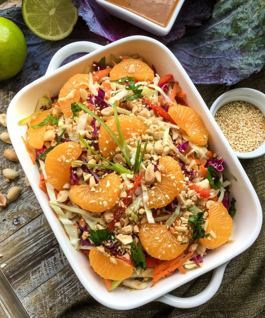 Asian cabbage salad with peanut dressing in a white dish