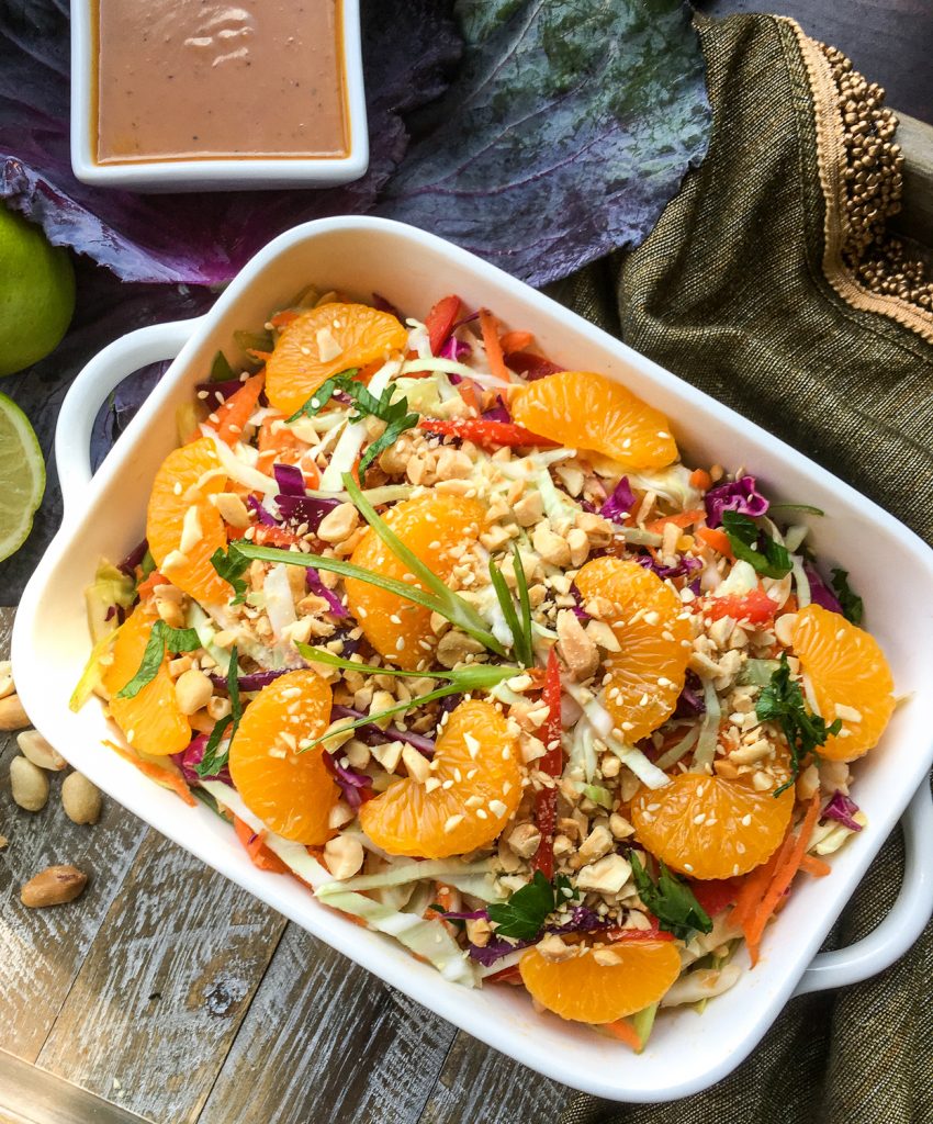 Asian cabbage salad with peanut dressing in a white dish