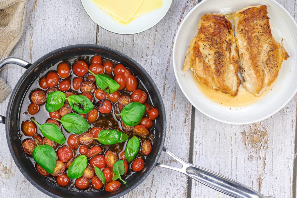 grape tomatoes in sauce with fresh basil