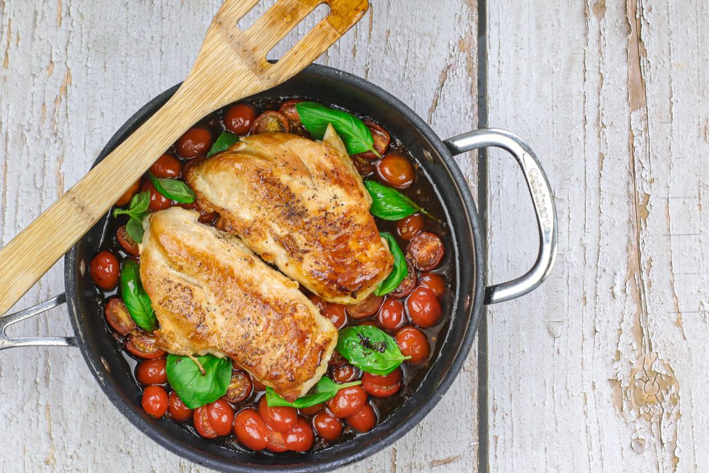 Chicken in sauce and tomatoes in a pan