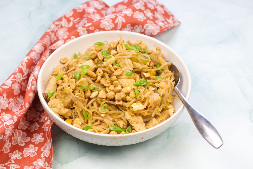 easy chicken pad thai in a white bowl