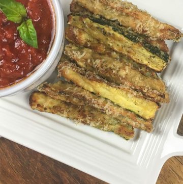 crispy zucchini fries on a white plate