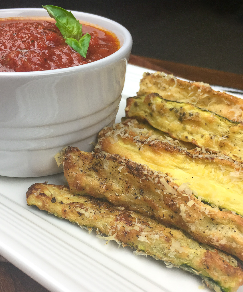 crispy zucchini fries on a white plate