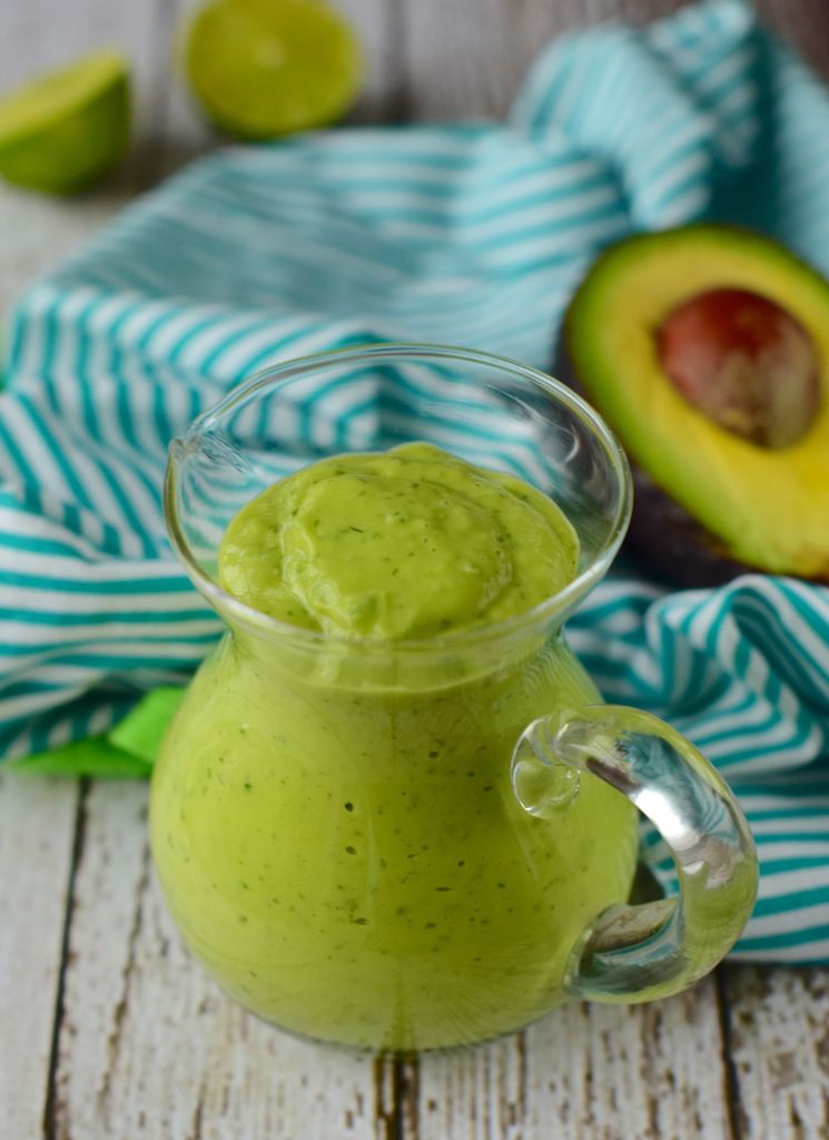 avocado lime dressing in a glass pitcher