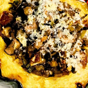 One half of an Stuffed Acorn Squash on a white plate