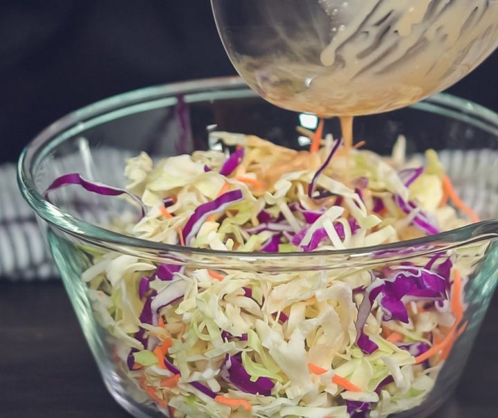 adding coleslaw dressing into the bowl