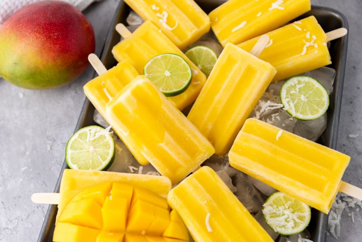 Coconut Lime Mango Popsicles together on a tray