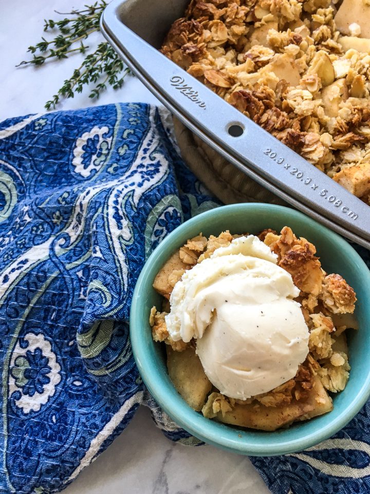 baked apple crisp in a bowl with a napkin