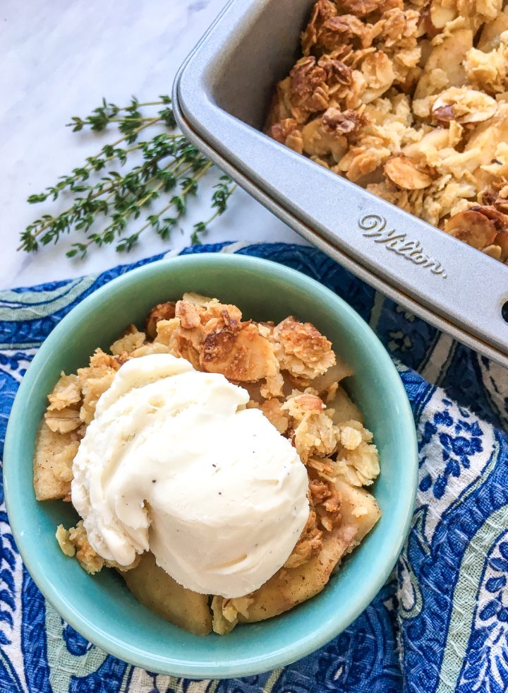 apple crisp in a bowl with ice cream