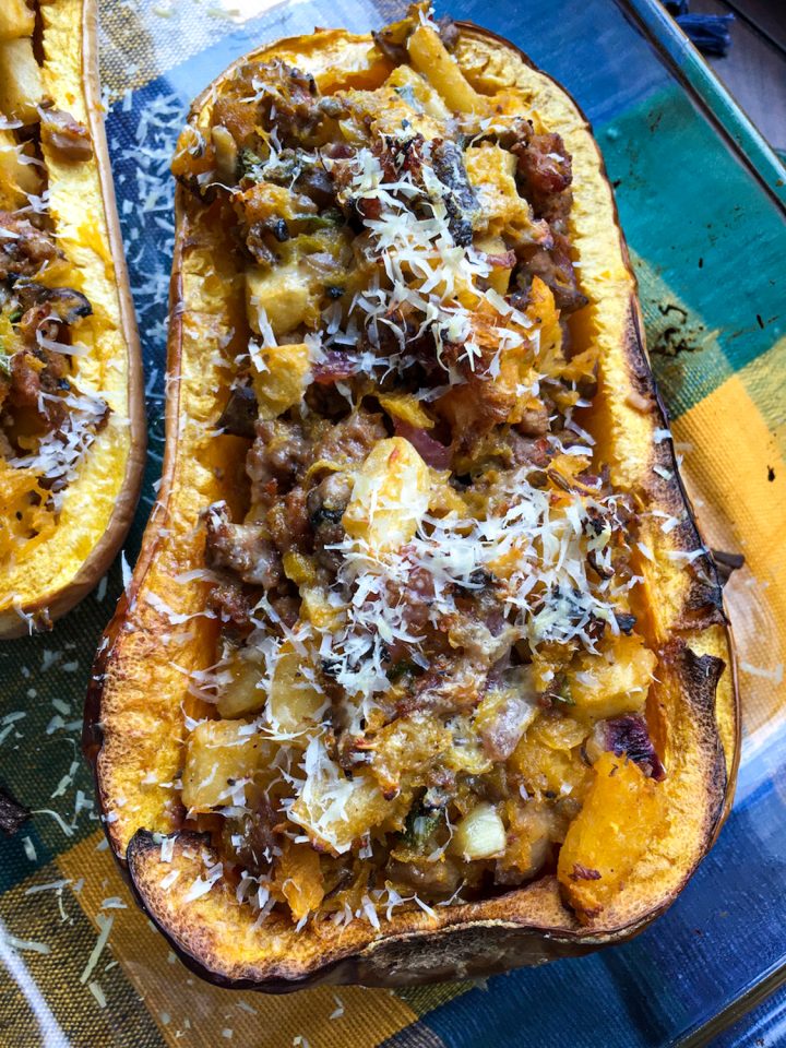 Apple Sausage Stuffed Butternut Squash against blue