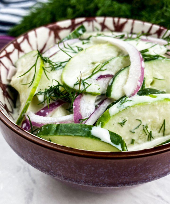 dill cucumber salad in a pretty bowl