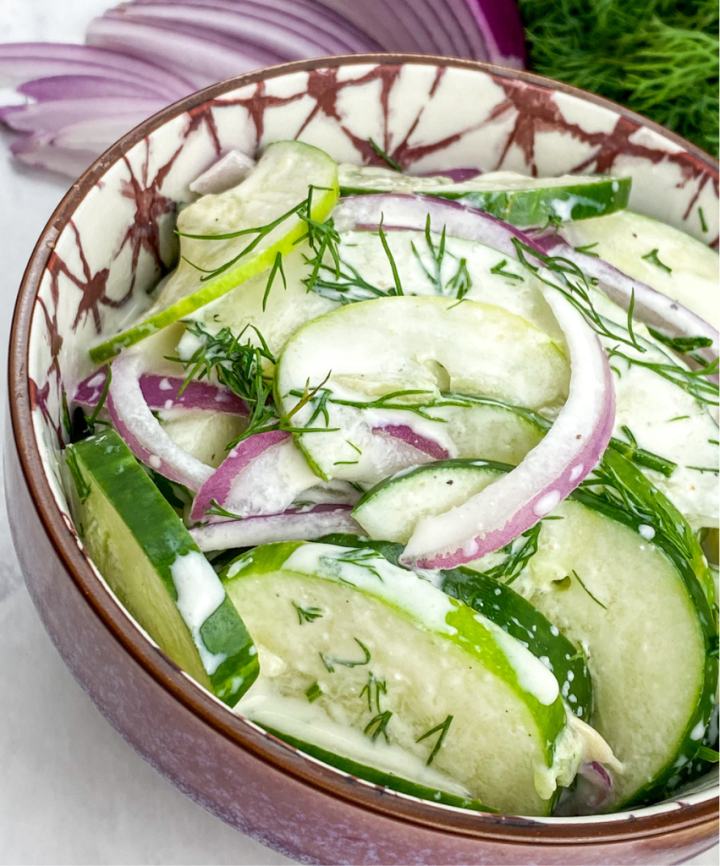 dill cucumber salad in a pretty bowl