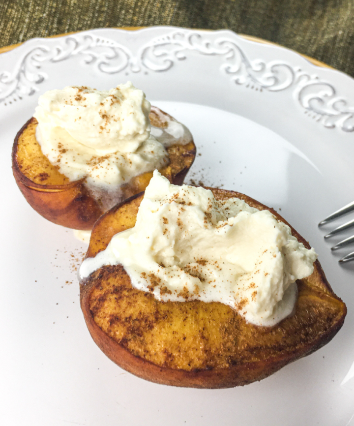 baked peaches on a white plate