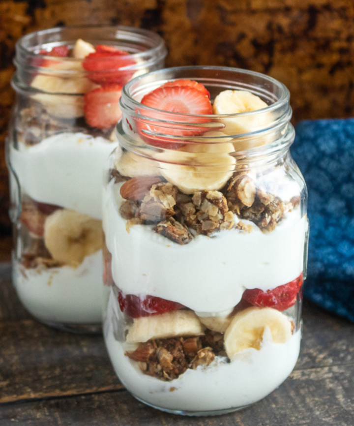 strawberry banana parfait with homemade granola in mason jar