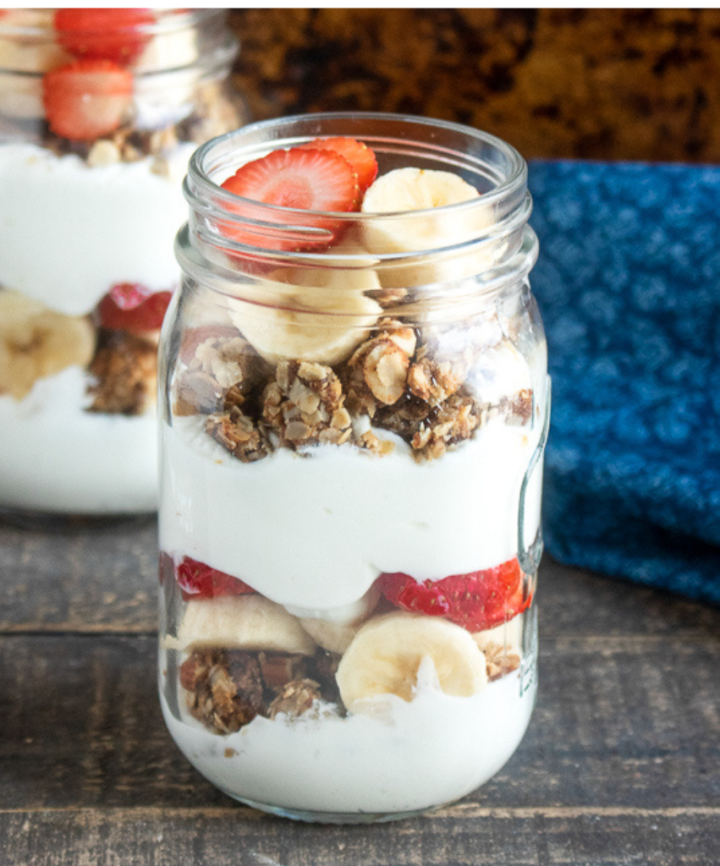  strawberry banana parfait with homemade granola in a mason jar