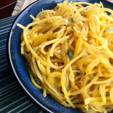 butternut squash noodles on a blue plate