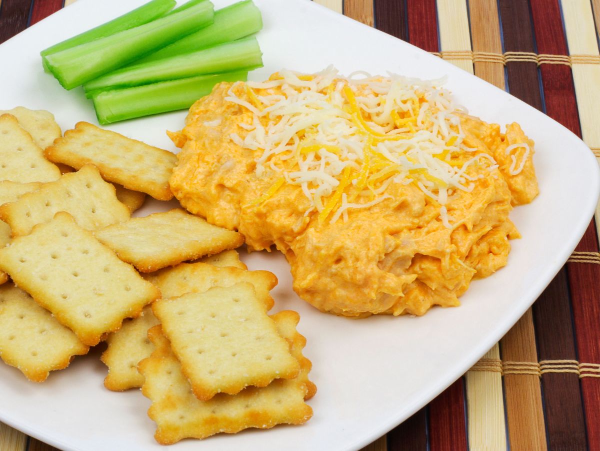 buffalo chicken dip with crackers and celery