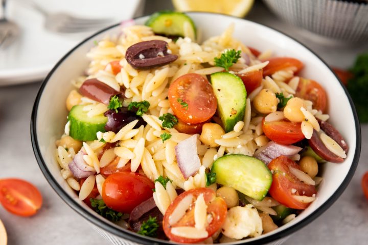 orzo pasta salad in a white bowl