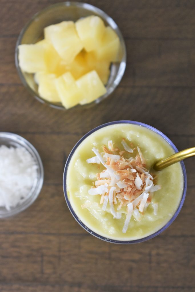 The Pineapple Avocado Smoothie on a wooden table.