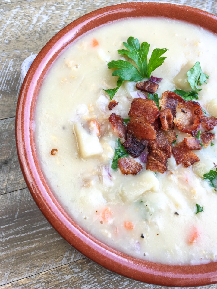 new england clam chowder in a brownish bowl