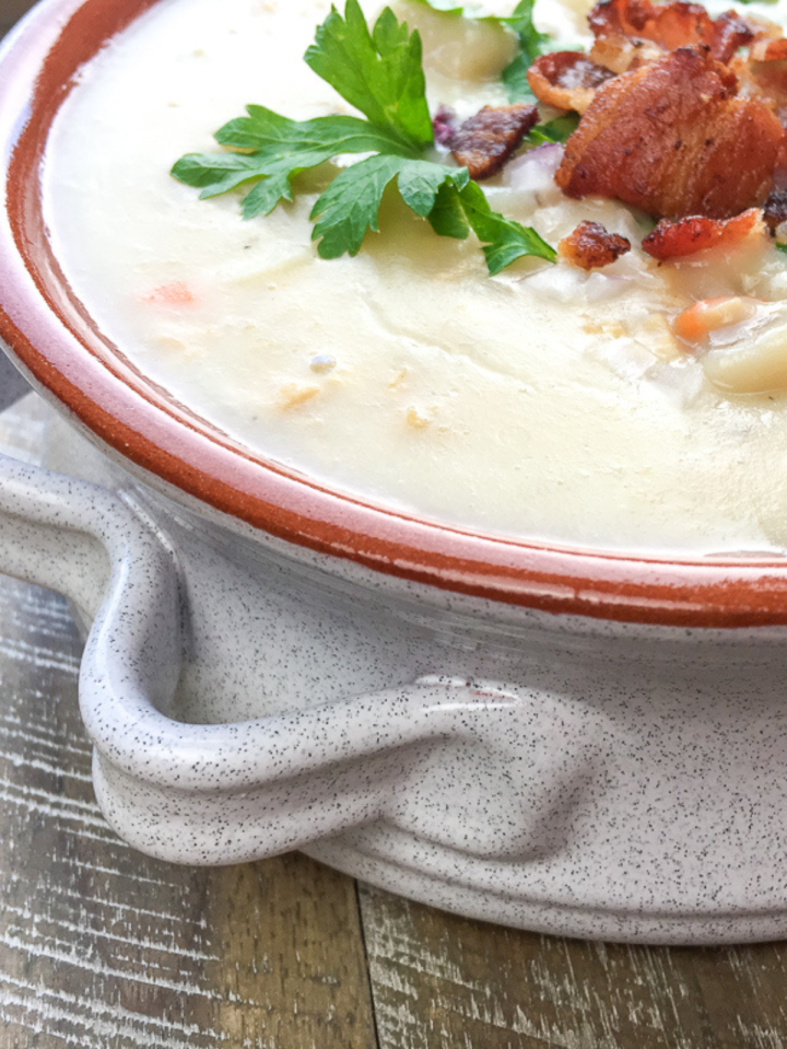 new england clam chowder in a brownish bowl