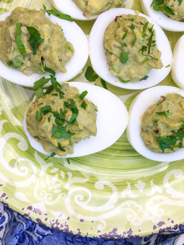 Avocado Deviled Eggs on a green plate