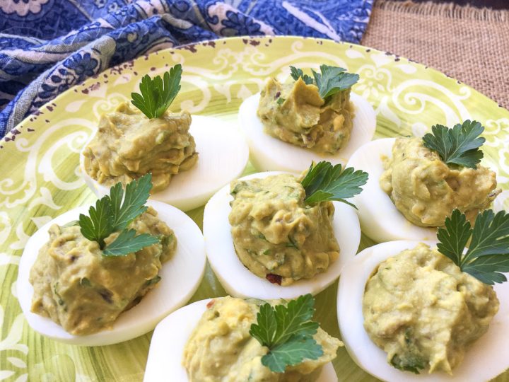 Avocado Deviled Eggs on a green plate