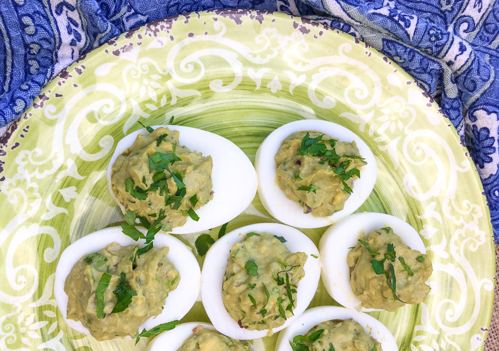 Avocado Deviled Eggs on a greenish plate