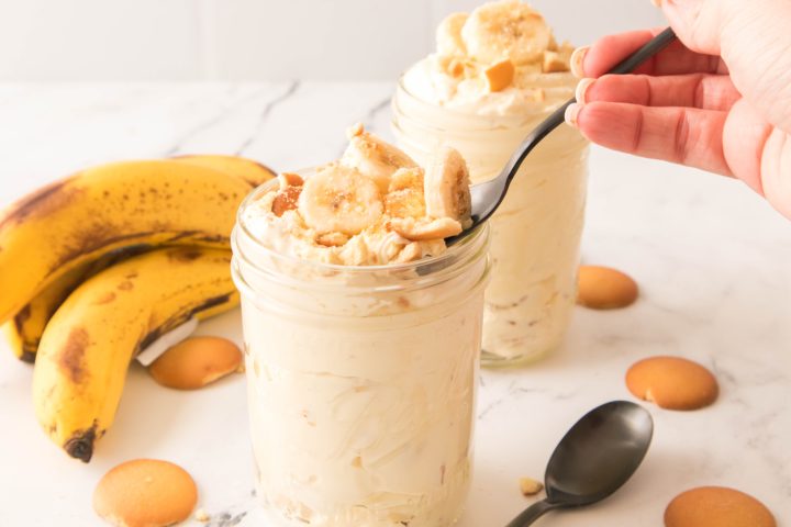 Banana pudding in a jar with a spoon in it 