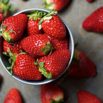 Overhead view of strawberries in bowl on table