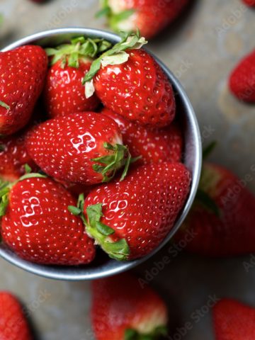 Overhead view of strawberries in bowl on table