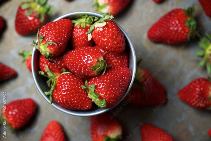Overhead view of strawberries in bowl on table